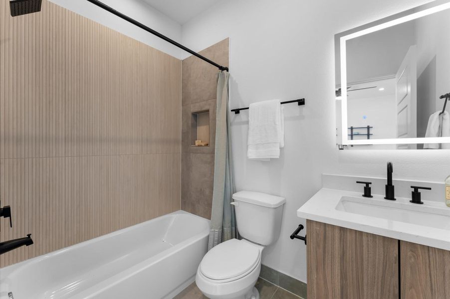 This first-floor full bathroom, located within a secondary bedroom, features a sleek vanity with a quartz countertop and a convenient shower/tub combo, blending modern finishes with everyday functionality for comfort and style. This first-floor full bathroom, located within a secondary bedroom, features a sleek vanity with a quartz countertop and a convenient shower/tub combo, blending modern finishes with everyday functionality for comfort and style.