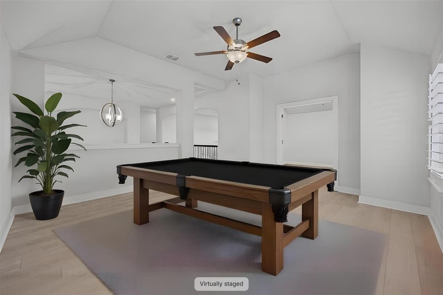 A spacious game room features a billiard table, creating an inviting space for leisure and entertainment.