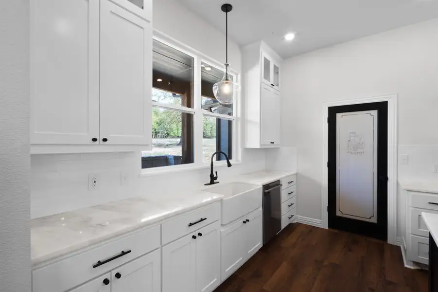 Kitchen featuring glass insert cabinets, tasteful backsplash, white cabinetry, dishwasher, and dark wood-style flooring