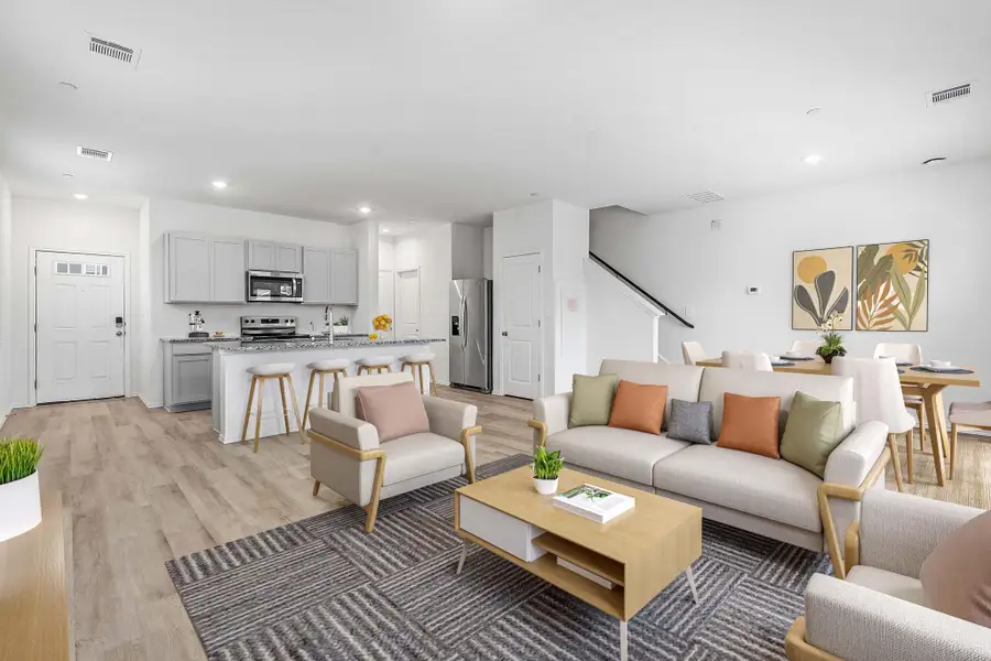 Open-concept living space featuring wood-finish flooring Open-concept living space featuring wood-finish flooring