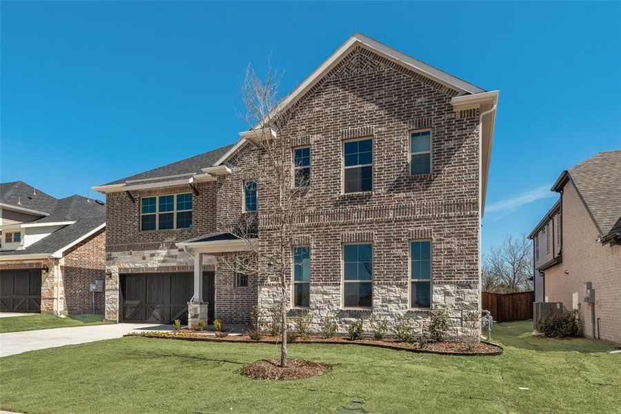 Front exterior of a new home in Valencia On The Lake, Little Elm, TX, highlighting curb appeal (Image 17).
