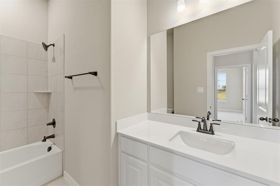 Full bathroom featuring bathtub / shower combination and vanity Full bathroom featuring bathtub / shower combination and vanity