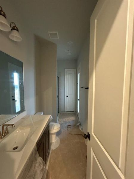 Full bath with a shower stall and vanity