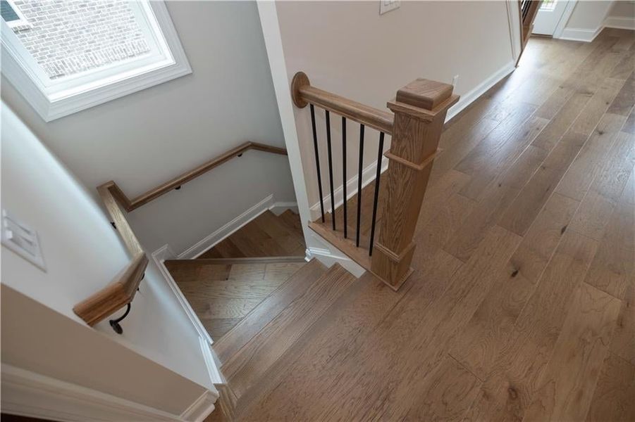 Stairway featuring wood-type flooring