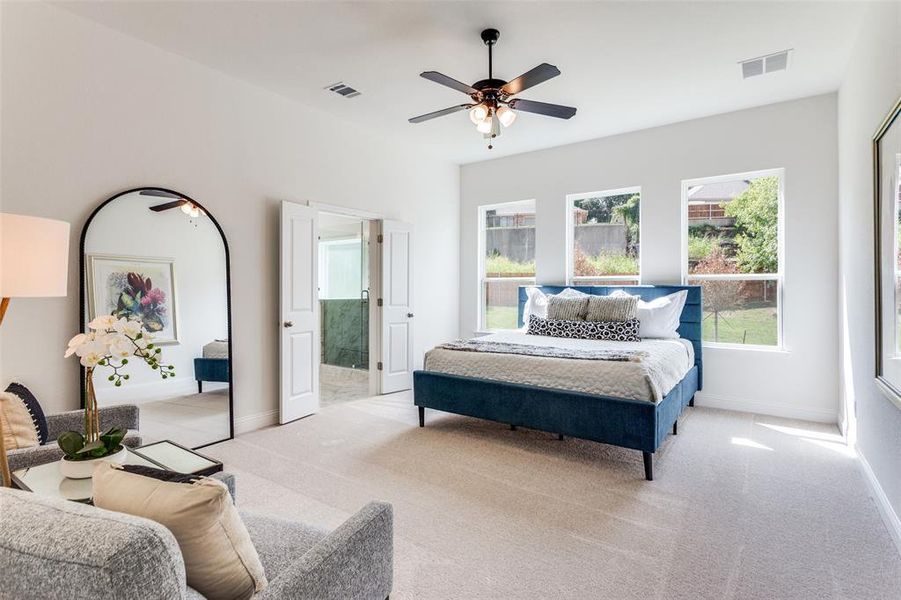 Bedroom featuring light carpet and ceiling fan