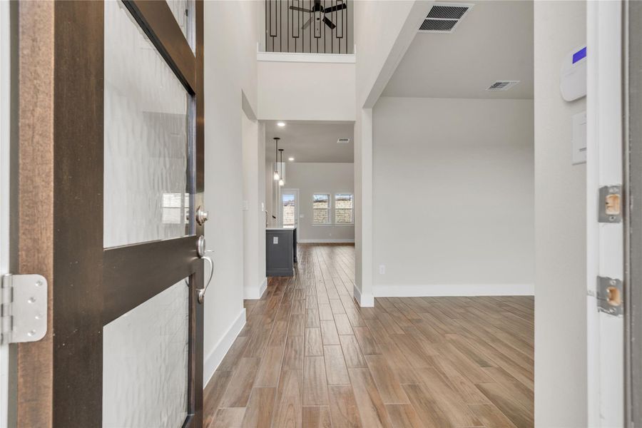 Step into a generously proportioned entry, offering an inviting view into the main living spaces.