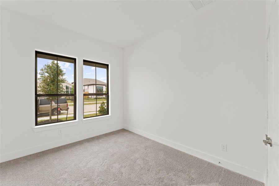 ** REPRESENTATION PHOTO OF THE SAME FLOOR PLAN, FINISHES WILL VARY** Secondary downstairs bedroom with a full bathroom! Plenty of natural lighting allows this room to double as an office space.