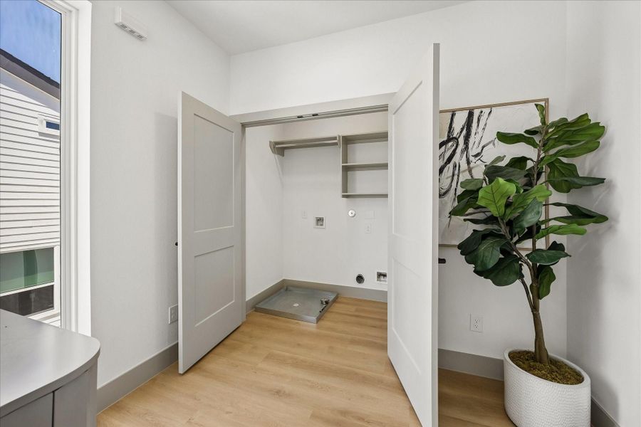 Dedicated laundry room offers washer and dryer connections, built in shelving for storage, and additional space to keep household essentials organized. Dedicated laundry room offers washer and dryer connections, built in shelving for storage, and additional space to keep household essentials organized.