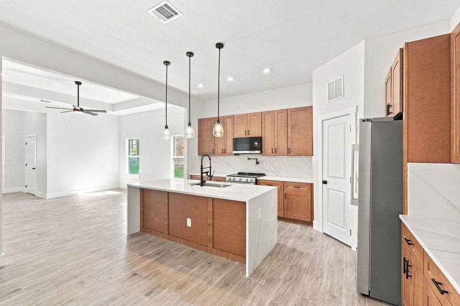 Warm, natural wood-toned shaker cabinets offering extensive storage and a timeless aesthetic.