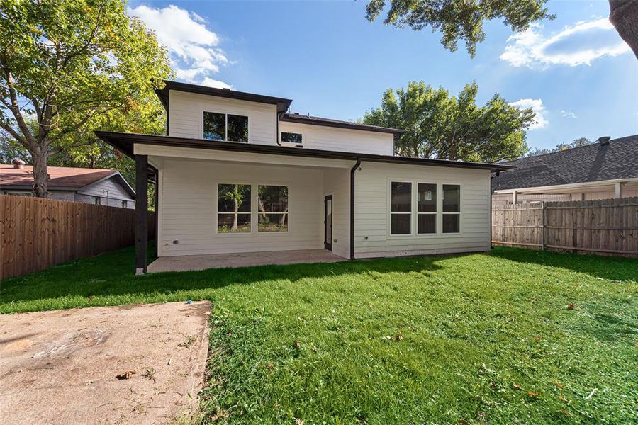 Back of property featuring a yard and a patio area