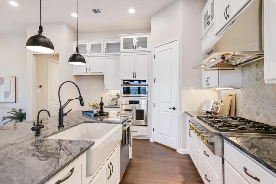 Custom granite counters, a farmhouse sink and upgraded appliances!