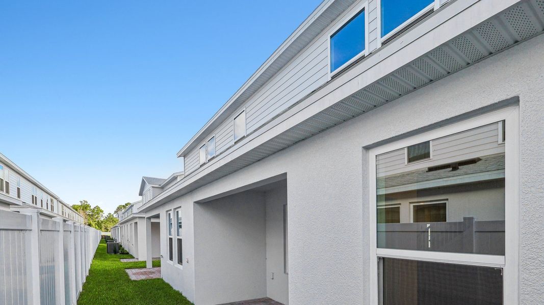 Exterior details and patio area of a home in Cyrene at Harmony, St. Cloud (Image 24).