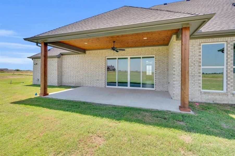 Rear view of property with a patio area and a lawn