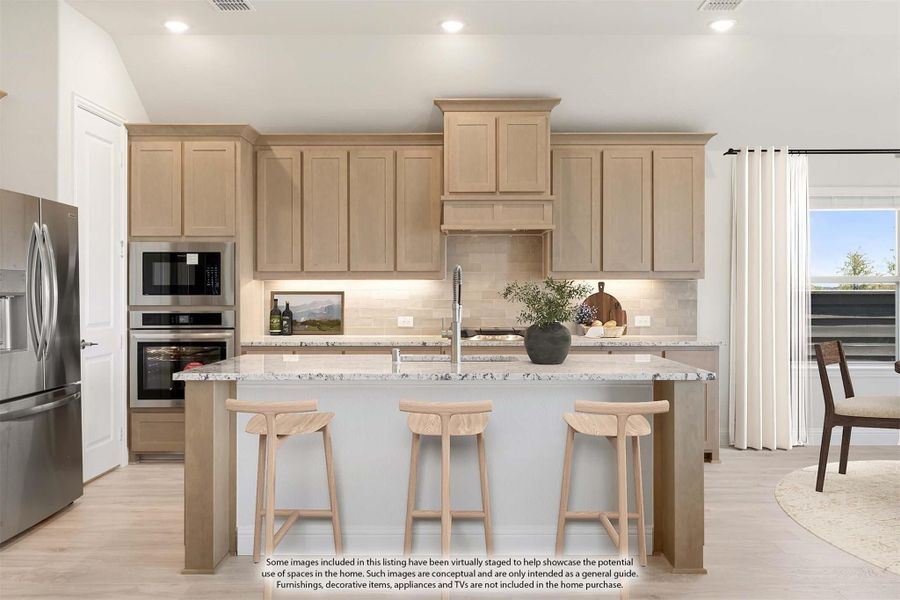 Kitchen with light wood cabinets, granite island, three bar stools, and stainless steel appliances