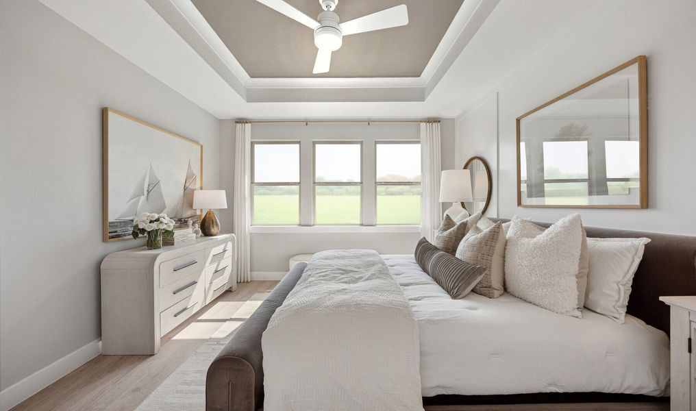 Primary suite with decorated feature wall & tray ceiling