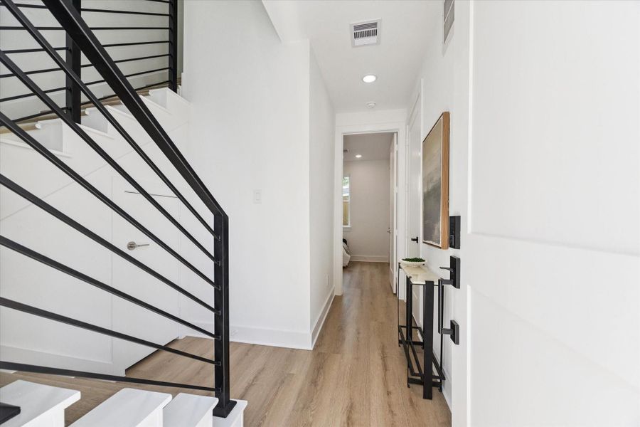 A formal entry is the ideal spot to drop keys, bags and leashes, and leads to the first floor bedroom with attached full bath. Visible through the stairway railing is wonderful storage space under the stairs. A formal entry is the ideal spot to drop keys, bags and leashes, and leads to the first floor bedroom with attached full bath. Visible through the stairway railing is wonderful storage space under the stairs.