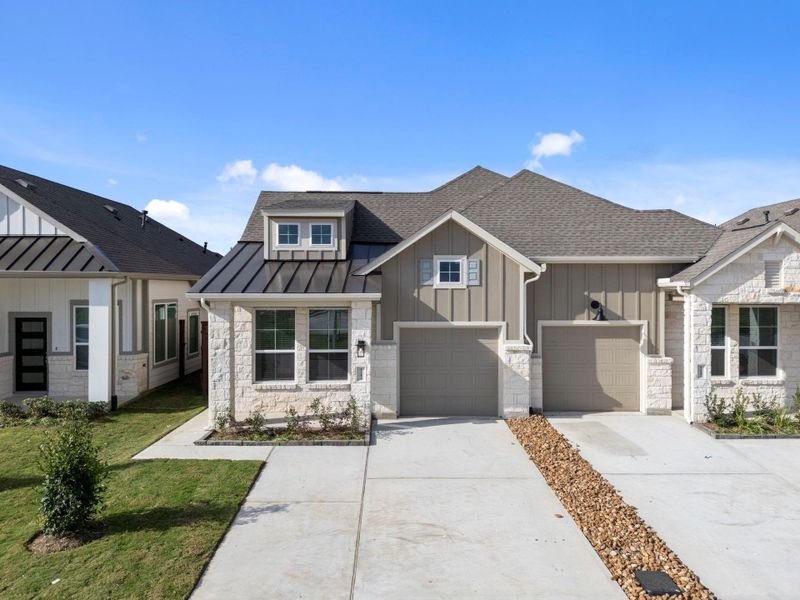 Front exterior of a new home in Meridiana, Iowa Colony, TX, highlighting curb appeal (Image 17).