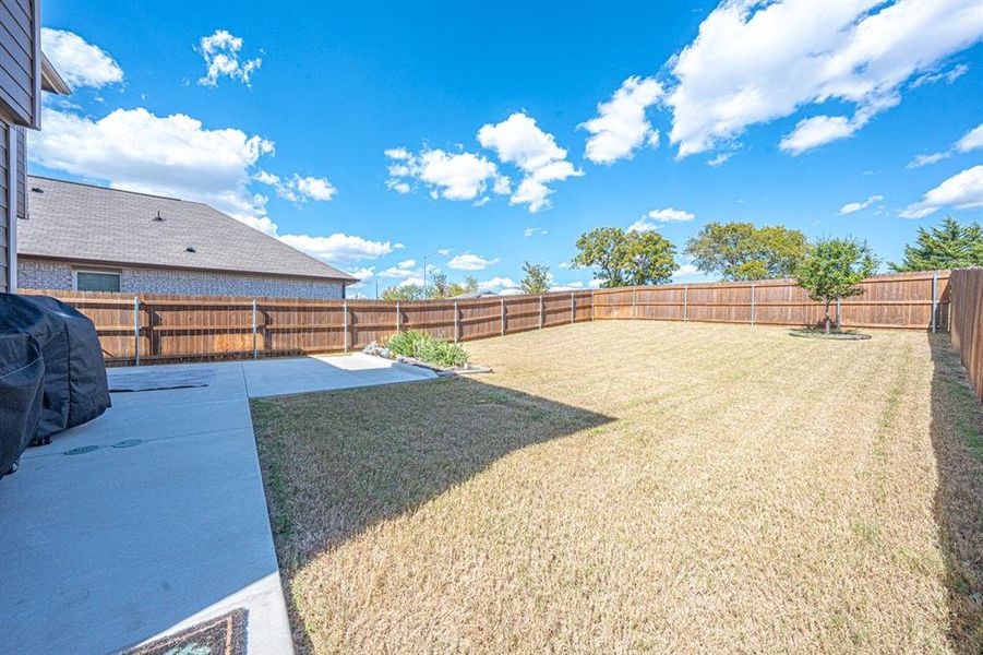 Fenced backyard with a patio