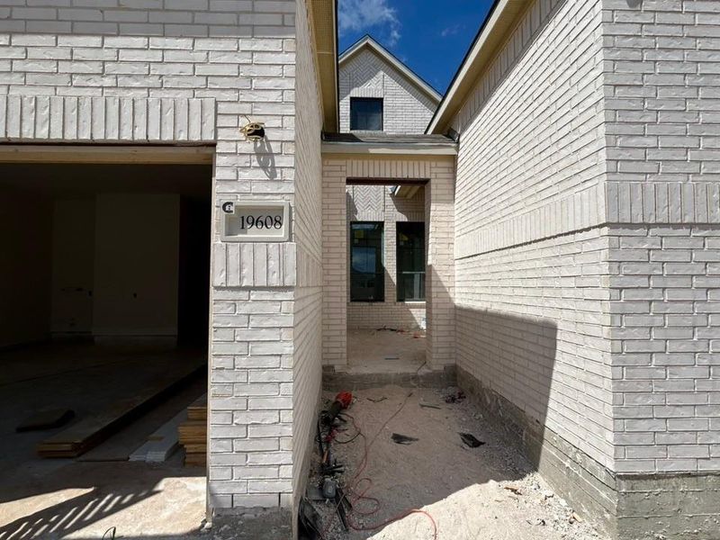 Doorway to property featuring brick siding Doorway to property featuring brick siding
