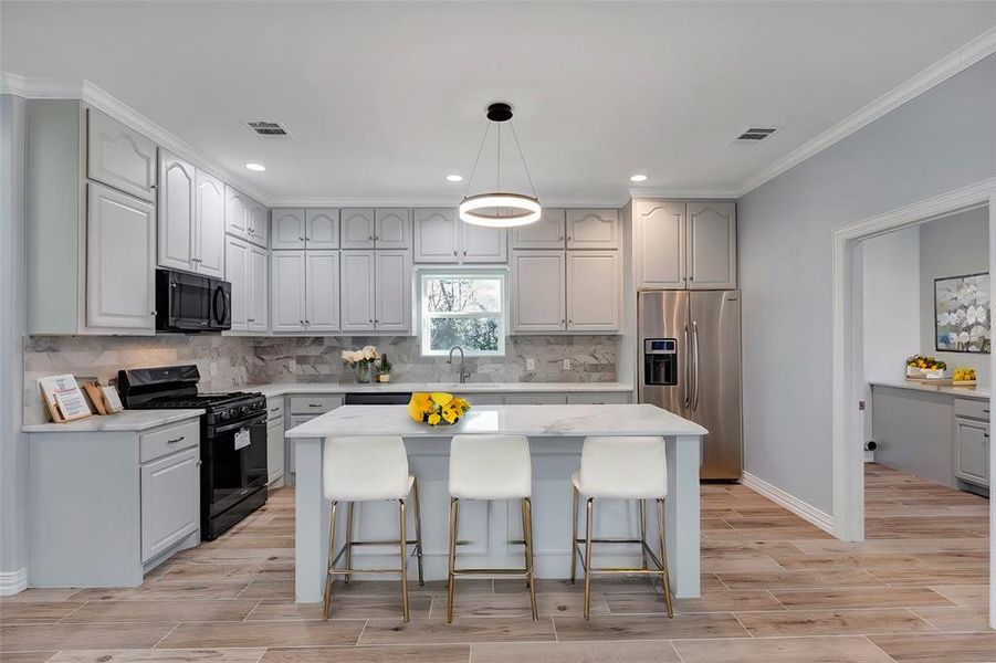 Kitchen is open to family room.  Quartz countertops and marble backsplash