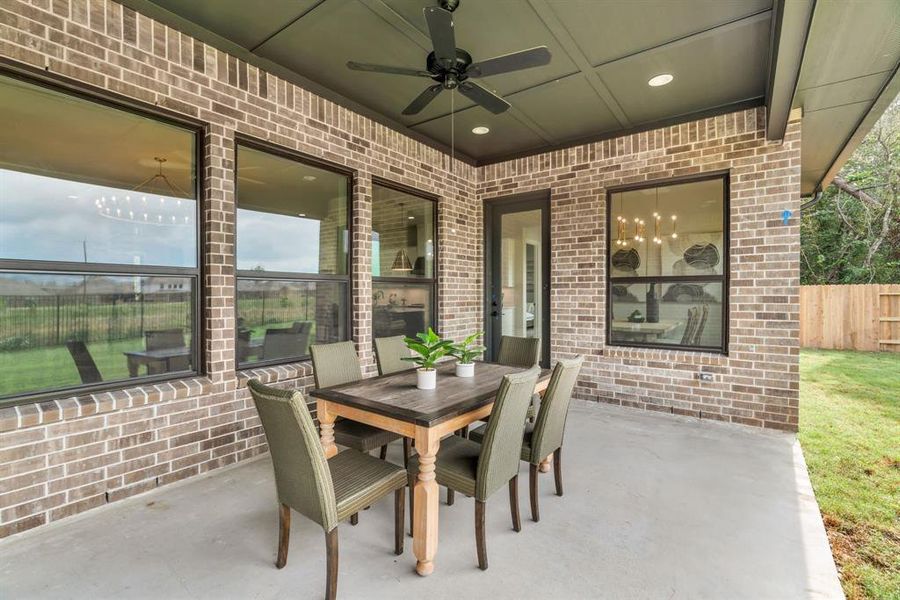 Spacious covered patio with a door to the dining