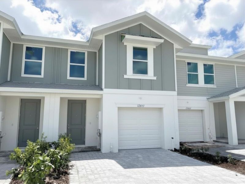 Front exterior of a new home in Meritage Homes at Central Park, Port St. Lucie, FL, highlighting curb appeal (Image 2). Front exterior of a new home in Meritage Homes at Central Park, Port St. Lucie, FL, highlighting curb appeal (Image 2).