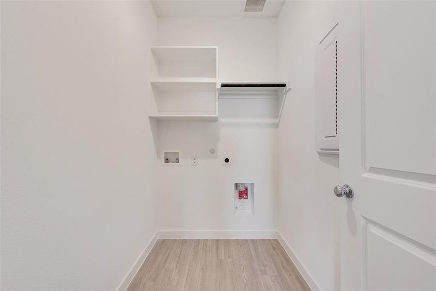 Laundry area featuring washer hookup, light wood-type flooring, hookup for a gas dryer, and hookup for an electric dryer