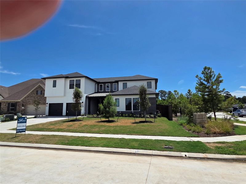 Front exterior of a new home in Evergreen 70', Conroe, TX, highlighting curb appeal (Image 25).