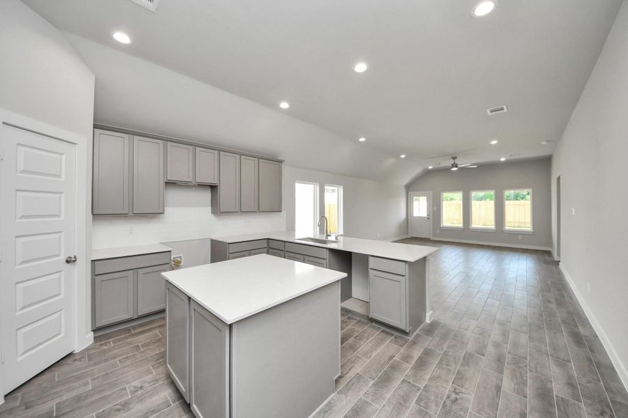 This generously spacious kitchen is a dream realized! With high ceilings, soft close cabinets, granite countertops, stainless steel appliances (To be Installed), a sleek tile backsplash, recessed lighting, and an extended counter area, it offers both style and practicality. All this opens up to the expansive family room, creating a perfect hub for gatherings. Sample photo of completed home with similar floor plan. Actual colors and selections may vary. This generously spacious kitchen is a dream realized! With high ceilings, soft close cabinets, granite countertops, stainless steel appliances (To be Installed), a sleek tile backsplash, recessed lighting, and an extended counter area, it offers both style and practicality. All this opens up to the expansive family room, creating a perfect hub for gatherings. Sample photo of completed home with similar floor plan. Actual colors and selections may vary.