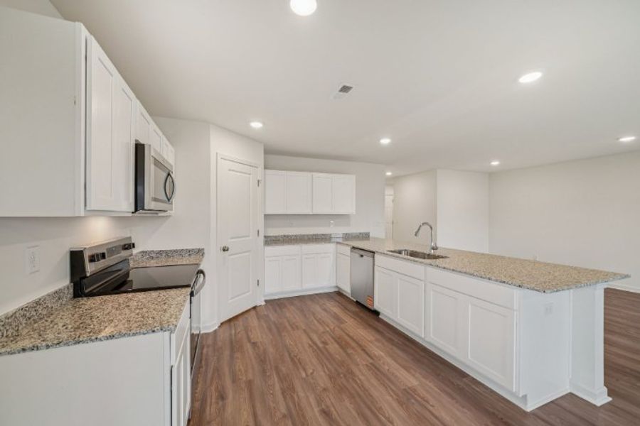 A kitchen with white cabinets. A kitchen with white cabinets.
