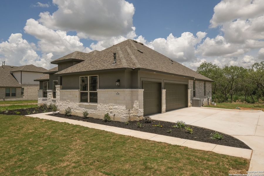 Front exterior of a new home in Everly Estates, San Antonio, TX, highlighting curb appeal (Image 16).