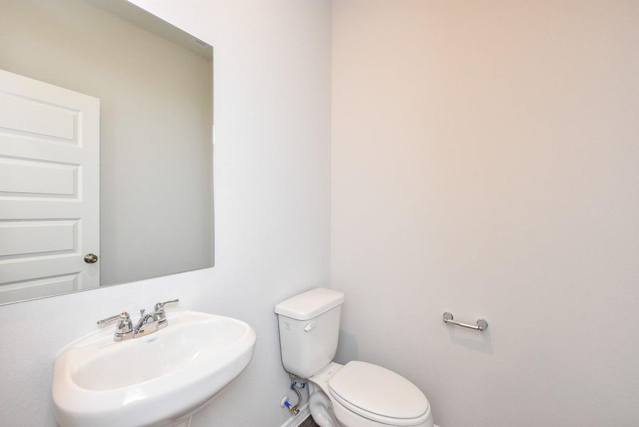 This is the delightful half-bath with lovely petite sink. This is the delightful half-bath with lovely petite sink.