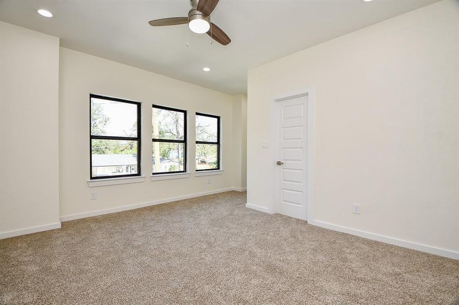 The second of the secondary bedrooms, this room boasts a neutral palette of carpets and walls and ample closet space.