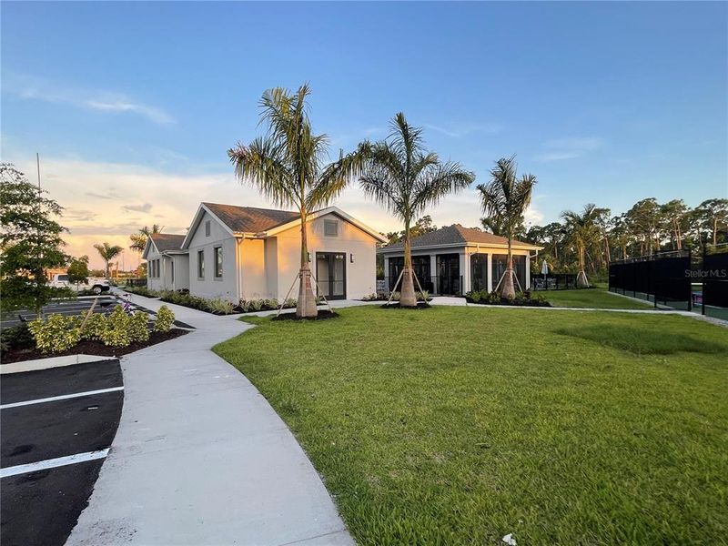 Front exterior of a new home in Island Lakes at Coco Bay, Englewood, FL, highlighting curb appeal (Image 2).