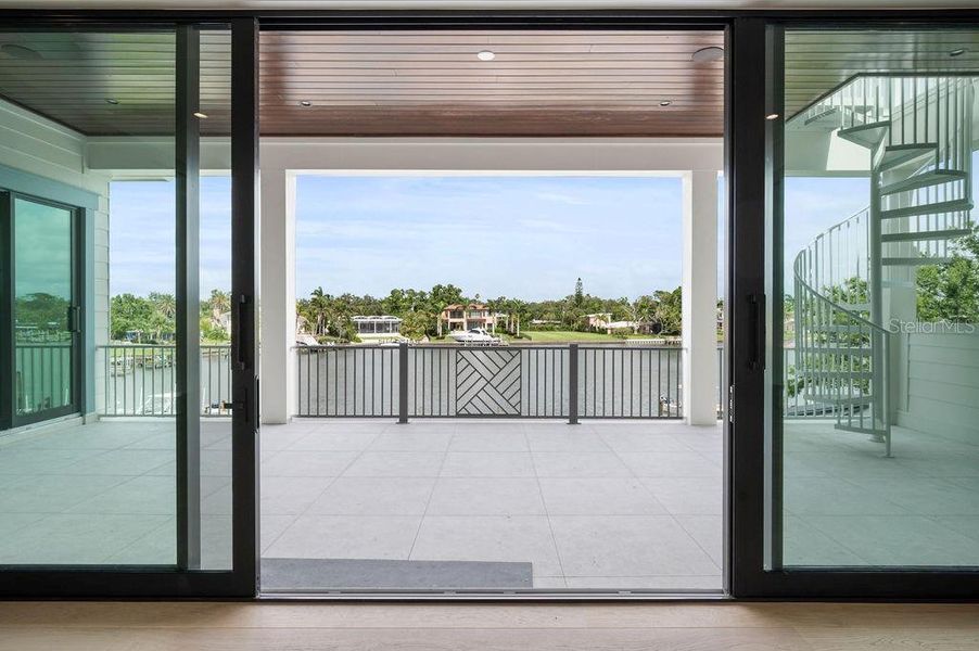 Hurricane Sliders on Spacious Second Story Terrace Opens to Water and City Views.