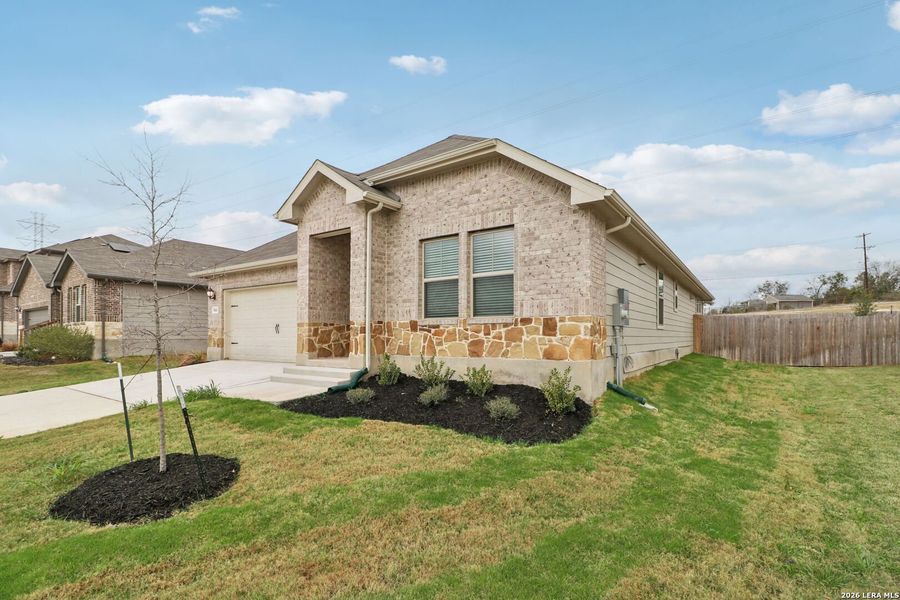 Front exterior of a new home in Legendary Trails - Classic Series, Cibolo, TX, highlighting curb appeal (Image 27).