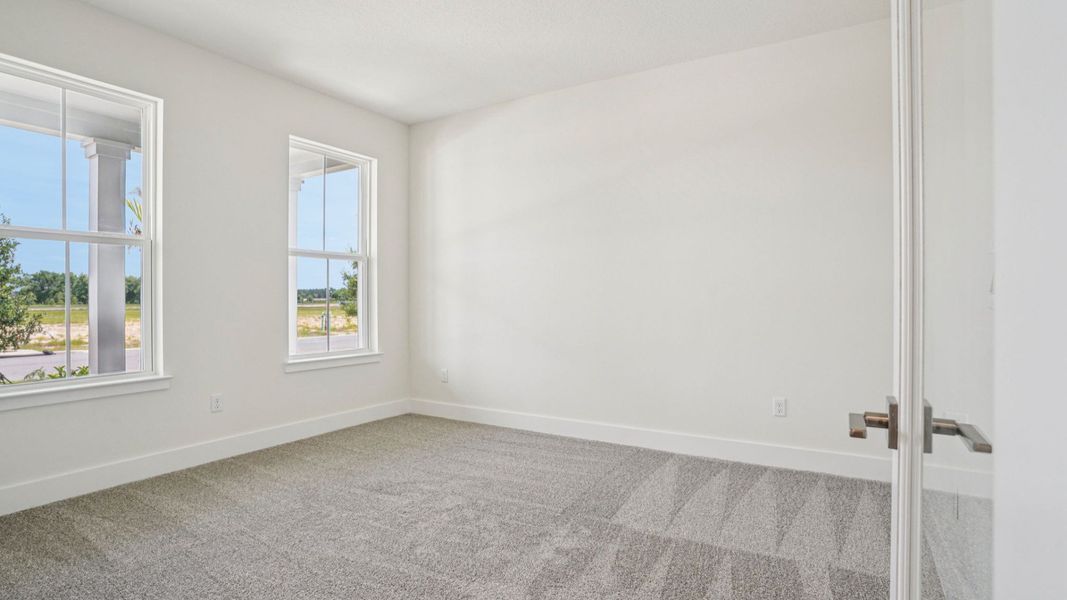 Spacious owner's suite with plush carpet in the Plumeria plan at Lakeside at Satilla by DRB Homes. Spacious owner's suite with plush carpet in the Plumeria plan at Lakeside at Satilla by DRB Homes.