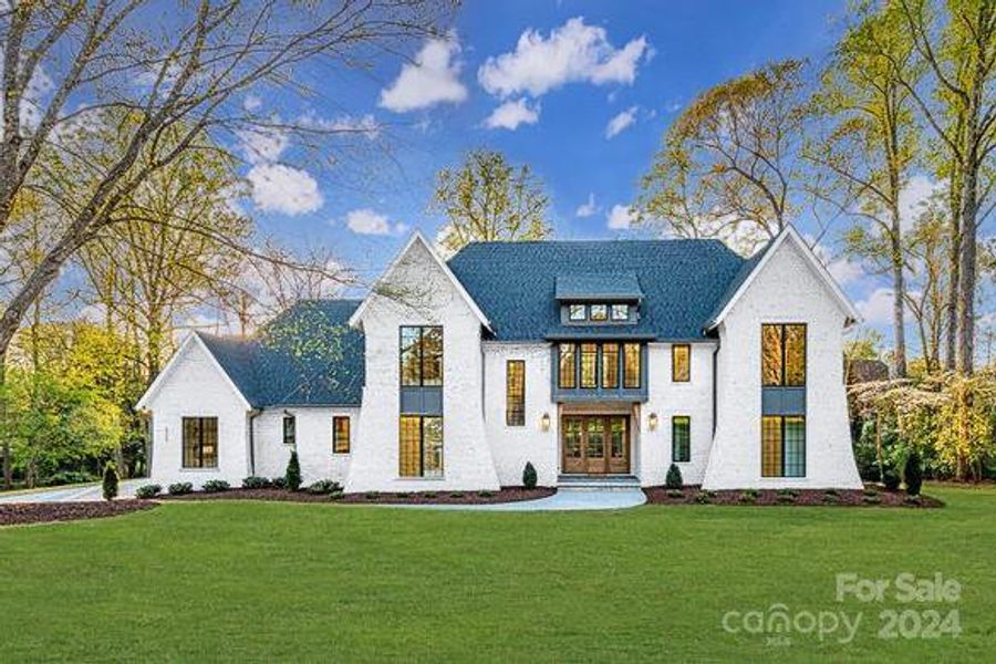 Conceptual example of what home will look like when complete! White brick, black Anderson Windows, sod, irrigation, landscaping.