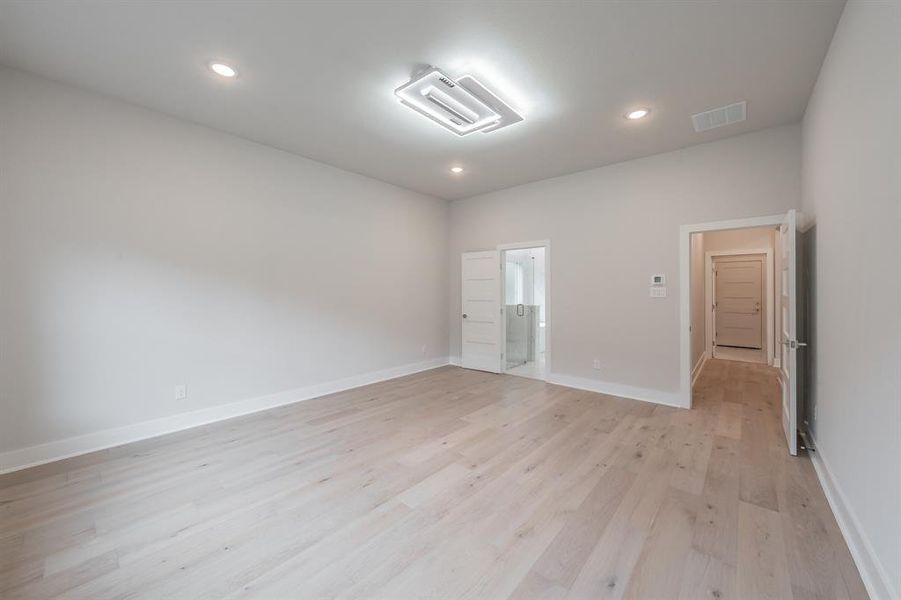 Spare room featuring light wood-style floors, cooling unit, and recessed lighting