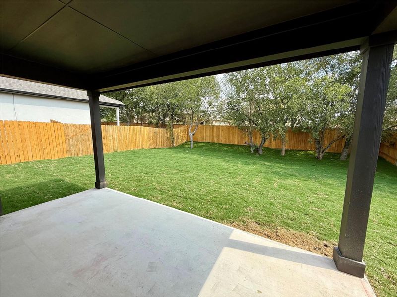 Fenced backyard with a patio area Fenced backyard with a patio area