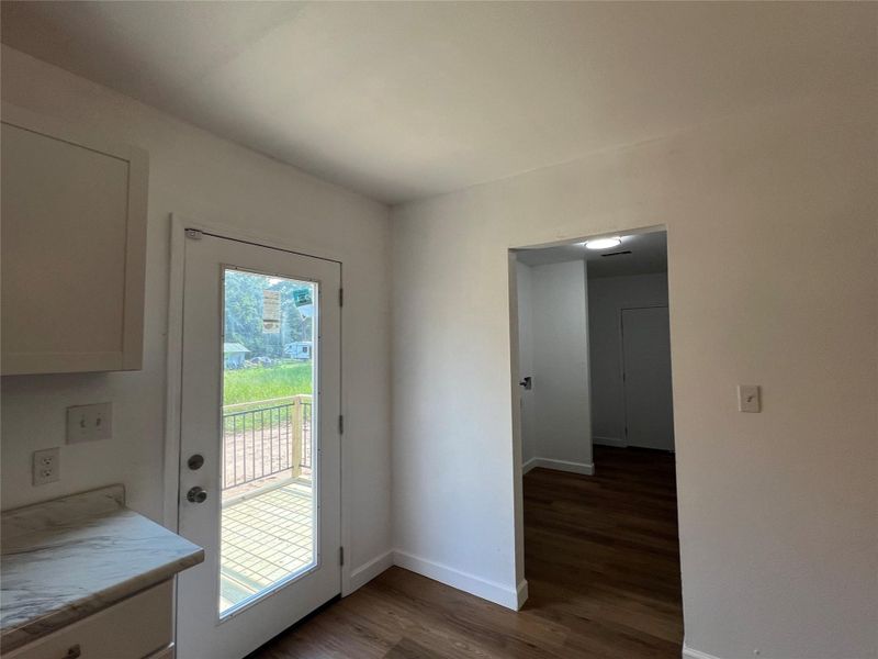 Looking from Kitchen to Utility with a stairway exit and to the left back door Looking from Kitchen to Utility with a stairway exit and to the left back door