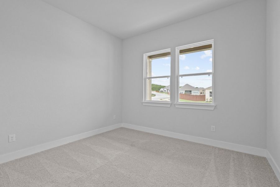 A room with a window and a carpet. A room with a window and a carpet.