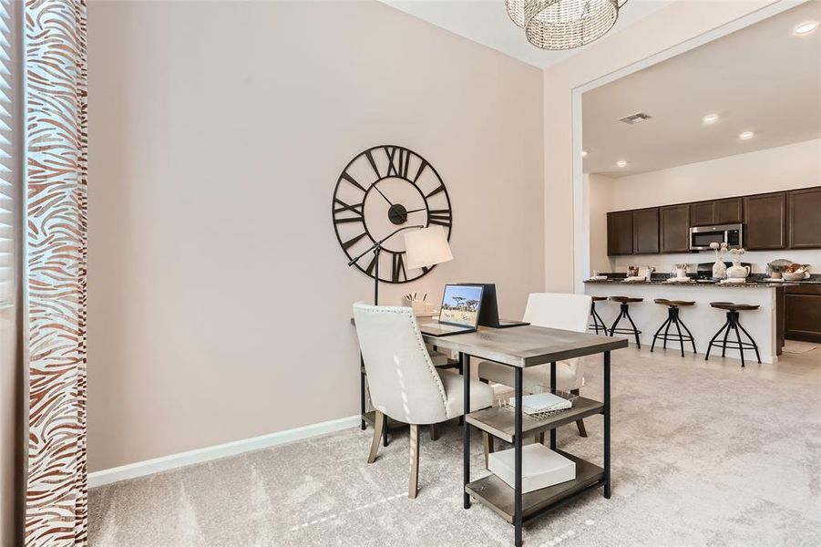 Dining area featuring recessed lighting and light carpet