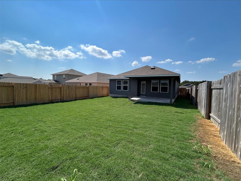 Rear view of property with a patio and a fenced backyard
