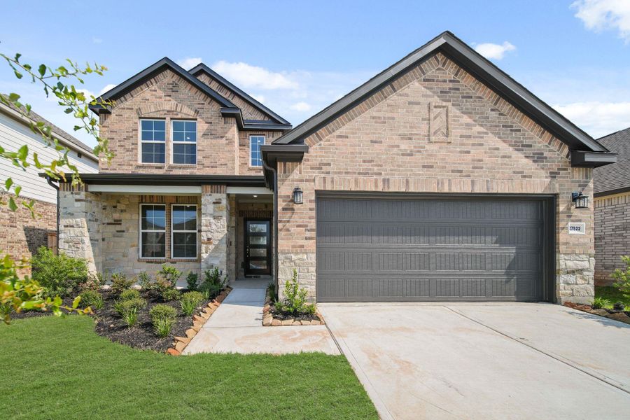 Front exterior of a new home in Sunterra, Katy, TX, highlighting curb appeal (Image 18). Front exterior of a new home in Sunterra, Katy, TX, highlighting curb appeal (Image 18).