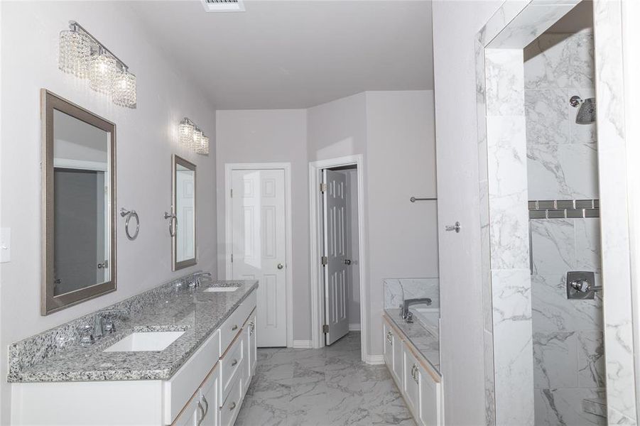 Bathroom featuring a tub to relax in and vanity