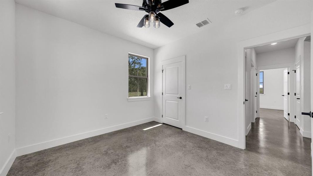 Sizable bedroom with stained concrete!