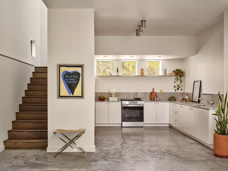 Open kitchen with wall of storage and don't forget to peek into the hidden closet to keep everything you don't need tucked away Open kitchen with wall of storage and don't forget to peek into the hidden closet to keep everything you don't need tucked away
