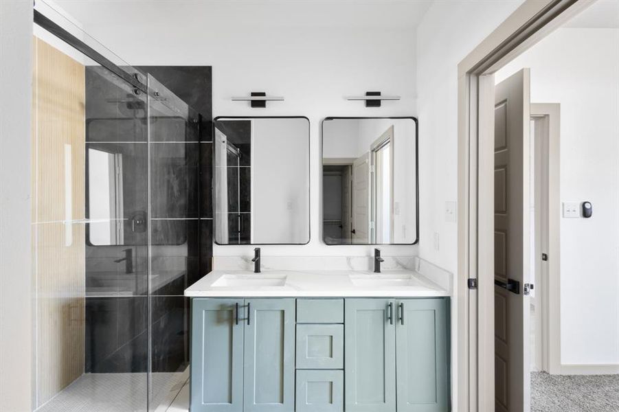 Full bathroom with a sink, double vanity, and a stall shower Full bathroom with a sink, double vanity, and a stall shower