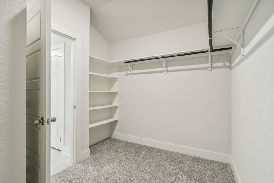 Primary suite walk-in closet in the Hughes floorplan at a Meritage Homes community.